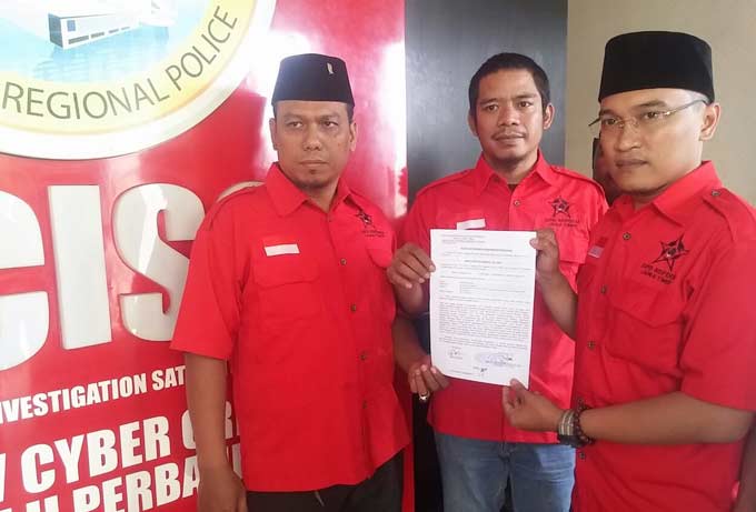 Ketua DPD Repdem Jawa Timur, Abdi Edison memperlihatkan laporan polisi kepada awak media. foto: DIDI ROSADI/ BANGSAONLINE
