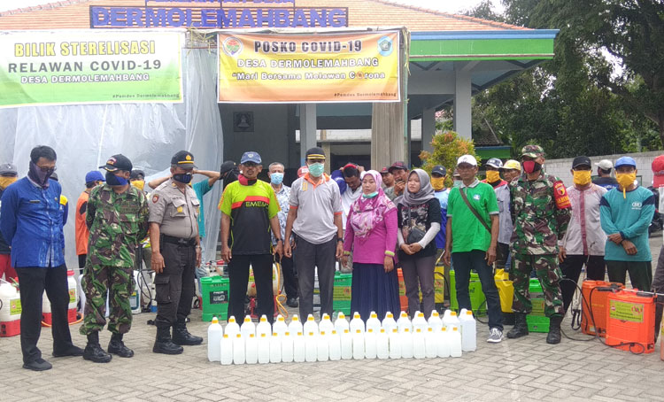 Kepala Desa Dermolemahbanh Amari bersama Muspika dan relawan foto bareng dengan 'peralatan perang' untuk melawan Covid-19.