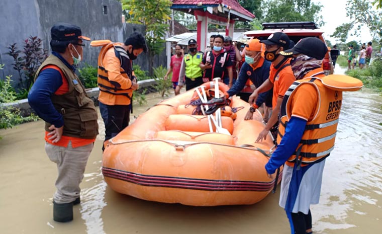 Petugas BPBD menyiapkan perahu karet untuk menyisir desa-desa di Kecamatan Benjeng yang terendam banjir. foto: ist.