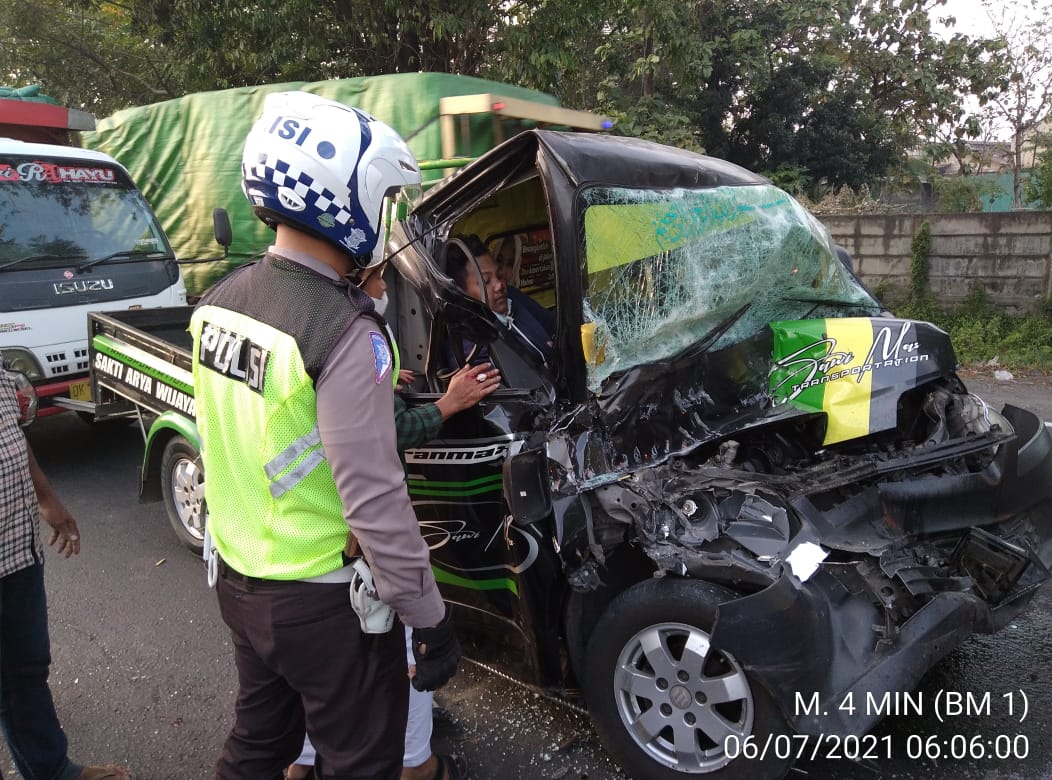 Petugas berupaya mengevakuasi sopir pikap yang sempat terjepit di dalam kabin mobil.