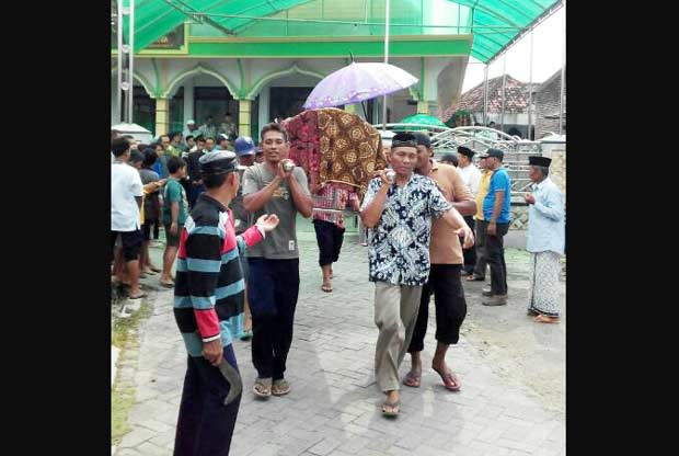 Dua jenazah suami istri usai disalatkan di musala dan diberangkatkan ke pemakaman.