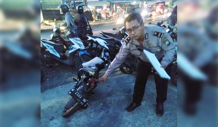 Petugas menunjukkan kondisi kendaraan Suzuki Satria yang terlibat kecelakaan.