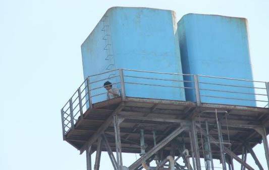 NEKAT. Siswandi yang nekad hendak bunuh diri loncat dari tower air PG Watutulis karena tak diizinkan nikah. foto: khumaidi/BANGSAONLINE